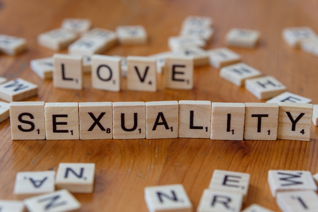 Scrabble tiles spelling love, sex, and sexuality