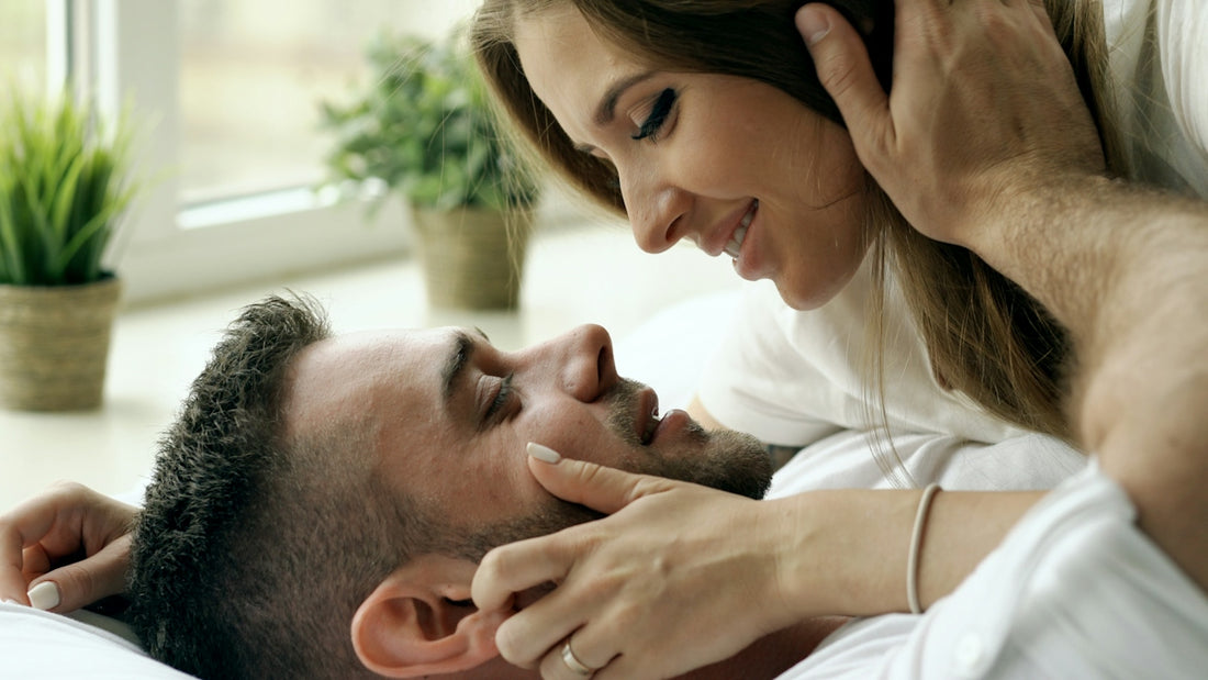 Couple lying together by a window